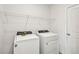 Laundry room with washer, dryer, and overhead shelving at 164 Lazy Shore Dr, Nokomis, FL 34275