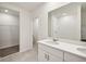 Main bathroom with double vanity, walk-in shower, and large closet at 164 Lazy Shore Dr, Nokomis, FL 34275