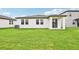 Home exterior showcasing a covered patio and a spacious backyard at 164 Lazy Shore Dr, Nokomis, FL 34275