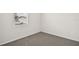 Simple bedroom with gray carpet and a window at 164 Lazy Shore Dr, Nokomis, FL 34275