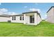 Home exterior showcasing a covered patio and a spacious backyard at 164 Lazy Shore Dr, Nokomis, FL 34275