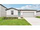 Modern one-story house with gray siding and a teal door at 164 Lazy Shore Dr, Nokomis, FL 34275