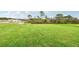 Open lot with lush green grass, ideal for new construction at 164 Lazy Shore Dr, Nokomis, FL 34275