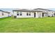Home exterior showcasing a covered patio and a spacious backyard at 164 Lazy Shore Dr, Nokomis, FL 34275