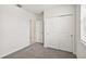 Bright bedroom with gray carpet, double door closet, and access to bathroom at 164 Lazy Shore Dr, Nokomis, FL 34275