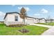 Modern one story house with gray siding and a teal door at 164 Lazy Shore Dr, Nokomis, FL 34275