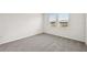 Spacious bedroom with gray carpet and large windows at 164 Lazy Shore Dr, Nokomis, FL 34275