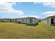 House with backyard, grassy lawn, and covered patio at 188 Lazy Shore Dr, Nokomis, FL 34275