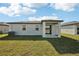 Home's backyard features a covered patio and a large lawn at 188 Lazy Shore Dr, Nokomis, FL 34275