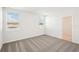 Bright bedroom with carpet flooring, two windows and access to a bathroom at 188 Lazy Shore Dr, Nokomis, FL 34275