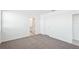 Well-lit bedroom featuring grey carpet, access to bathroom and additional room at 188 Lazy Shore Dr, Nokomis, FL 34275