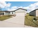 Single-story home with a two-car garage and well-manicured lawn at 188 Lazy Shore Dr, Nokomis, FL 34275