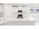 Modern kitchen with white cabinets and a large island at 188 Lazy Shore Dr, Nokomis, FL 34275