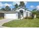Charming single-story home with well-manicured lawn, two car garage, and inviting front entrance at 7940 Fashion Loop, New Port Richey, FL 34654
