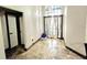 Bright foyer featuring tile flooring, front door with sidelights, and decorative light fixture at 7940 Fashion Loop, New Port Richey, FL 34654