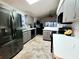 Modern kitchen featuring stainless steel appliances, countertops, and tile backsplash at 7940 Fashion Loop, New Port Richey, FL 34654
