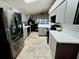 Modern kitchen featuring stainless steel appliances, countertops, and tile backsplash at 7940 Fashion Loop, New Port Richey, FL 34654