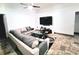 Cozy living room showcasing a large television, plush sofa, and stylish decor at 7940 Fashion Loop, New Port Richey, FL 34654
