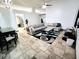 Spacious living room featuring an area rug, tile floors, and a comfortable sofa at 7940 Fashion Loop, New Port Richey, FL 34654