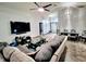 Open-concept living room with stylish furniture, large TV, and bright lighting at 7940 Fashion Loop, New Port Richey, FL 34654