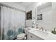 Clean bathroom with shower/tub combo, white vanity, and updated fixtures at 7940 Fashion Loop, New Port Richey, FL 34654