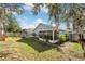 Large backyard with a fire pit, hammock, and screened patio at 7940 Fashion Loop, New Port Richey, FL 34654