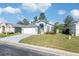 House exterior featuring a two-car garage and well-maintained lawn at 7940 Fashion Loop, New Port Richey, FL 34654