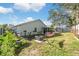 Spacious backyard with fire pit, hammock, and screened enclosure at 7940 Fashion Loop, New Port Richey, FL 34654
