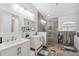 Modern bathroom with double vanity, large walk-in shower, and tile flooring at 7940 Fashion Loop, New Port Richey, FL 34654