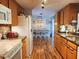 Bright kitchen with an eat-in dining area, hardwood floors, and ample cabinetry at 751 Nantucket Rd, Venice, FL 34293
