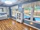 Sunroom with pool view, wood flooring, and coastal decor at 751 Nantucket Rd, Venice, FL 34293
