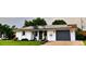 House exterior with solar panels, gray garage door and landscaped front yard at 751 Nantucket Rd, Venice, FL 34293