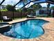 Inviting kidney shaped pool with spa and screened enclosure at 751 Nantucket Rd, Venice, FL 34293
