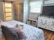 Main bedroom with a king-size bed, sliding barn door, and ample closet space at 751 Nantucket Rd, Venice, FL 34293