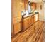 Kitchen with light wood cabinets, granite countertops, and hardwood floors at 751 Nantucket Rd, Venice, FL 34293
