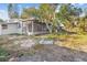 Overgrown backyard with a screened porch and some landscaping at 11357 116Th Ave, Largo, FL 33778