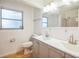 Bathroom with double vanity, toilet, and shower at 11357 116Th Ave, Largo, FL 33778