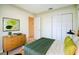 Bedroom with a green bed, closet, a wooden dresser, and a large mirror at 11357 116Th Ave, Largo, FL 33778
