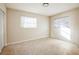 Spacious bedroom with two windows, closet, and terrazzo flooring at 11357 116Th Ave, Largo, FL 33778