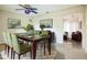 Dining room with wood table, green chairs, and view to the living area at 11357 116Th Ave, Largo, FL 33778