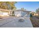 Exterior of the house with a gray garage and driveway at 11357 116Th Ave, Largo, FL 33778