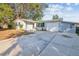 Front view of a single story home with a driveway and landscaping at 11357 116Th Ave, Largo, FL 33778