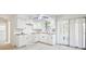Bright kitchen with white cabinets, wooden counters, and window at 11357 116Th Ave, Largo, FL 33778