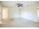 Living room with ceiling fan, speckled floors, doorway, and window with blinds at 11357 116Th Ave, Largo, FL 33778
