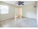Living room with ceiling fan, speckled flooring, and doorway at 11357 116Th Ave, Largo, FL 33778