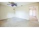 Living room with ceiling fan and view into kitchen area at 11357 116Th Ave, Largo, FL 33778