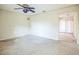 Living area with ceiling fan, speckled flooring, and sliding door at 11357 116Th Ave, Largo, FL 33778