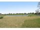 A tranquil backyard view featuring a pond and picturesque landscaping at 3910 Radiant Mountain Dr, Plant City, FL 33565