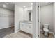 Bright bathroom featuring a double vanity with granite countertop and tile flooring with adjacent walk-in closet at 3910 Radiant Mountain Dr, Plant City, FL 33565