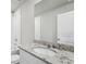 Bathroom featuring a granite countertop, white cabinets, and tiled shower at 3910 Radiant Mountain Dr, Plant City, FL 33565